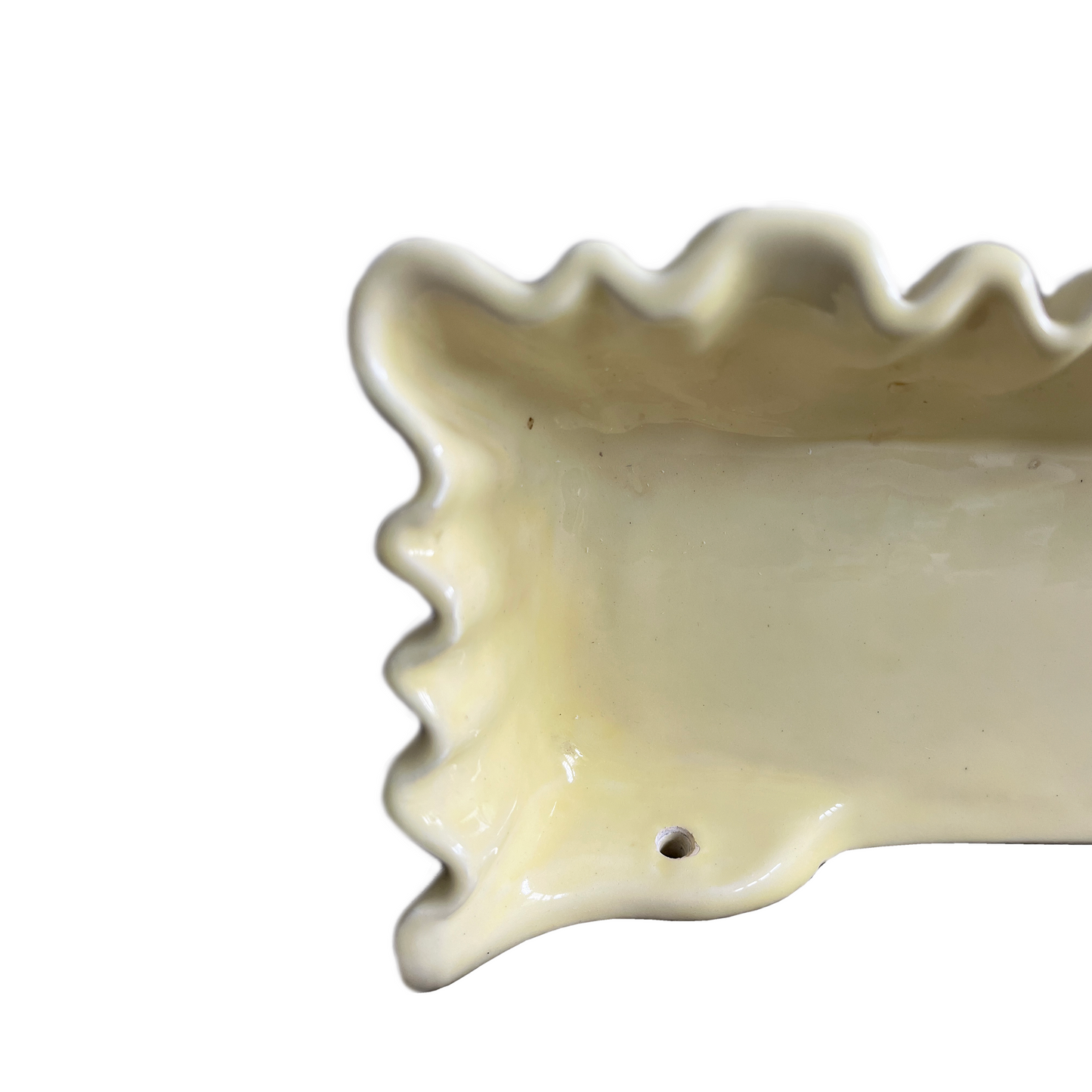 Close-up of soft pleated glaze detail on La Farnesiana butter yellow ceramic shelf