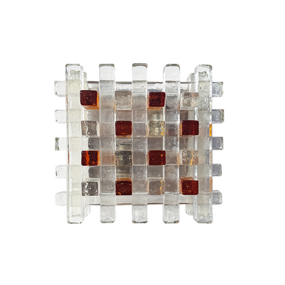 A square modular glass mosaic tile panel with a grid pattern of clear glass tiles and alternating translucent amber-brown and deep red glass inserts, shown on a plain white background.