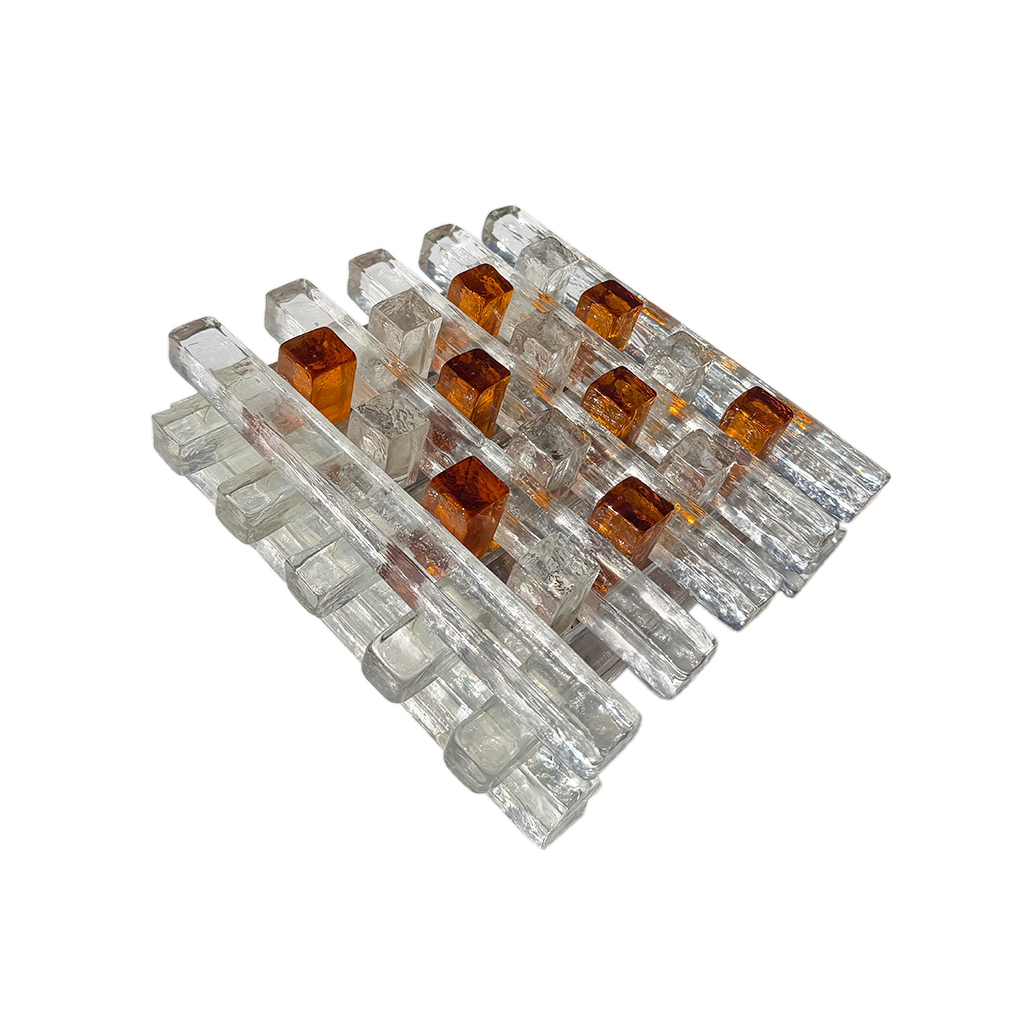 A set of modern mid-century style acrylic and glass block chairs on a solid white background.