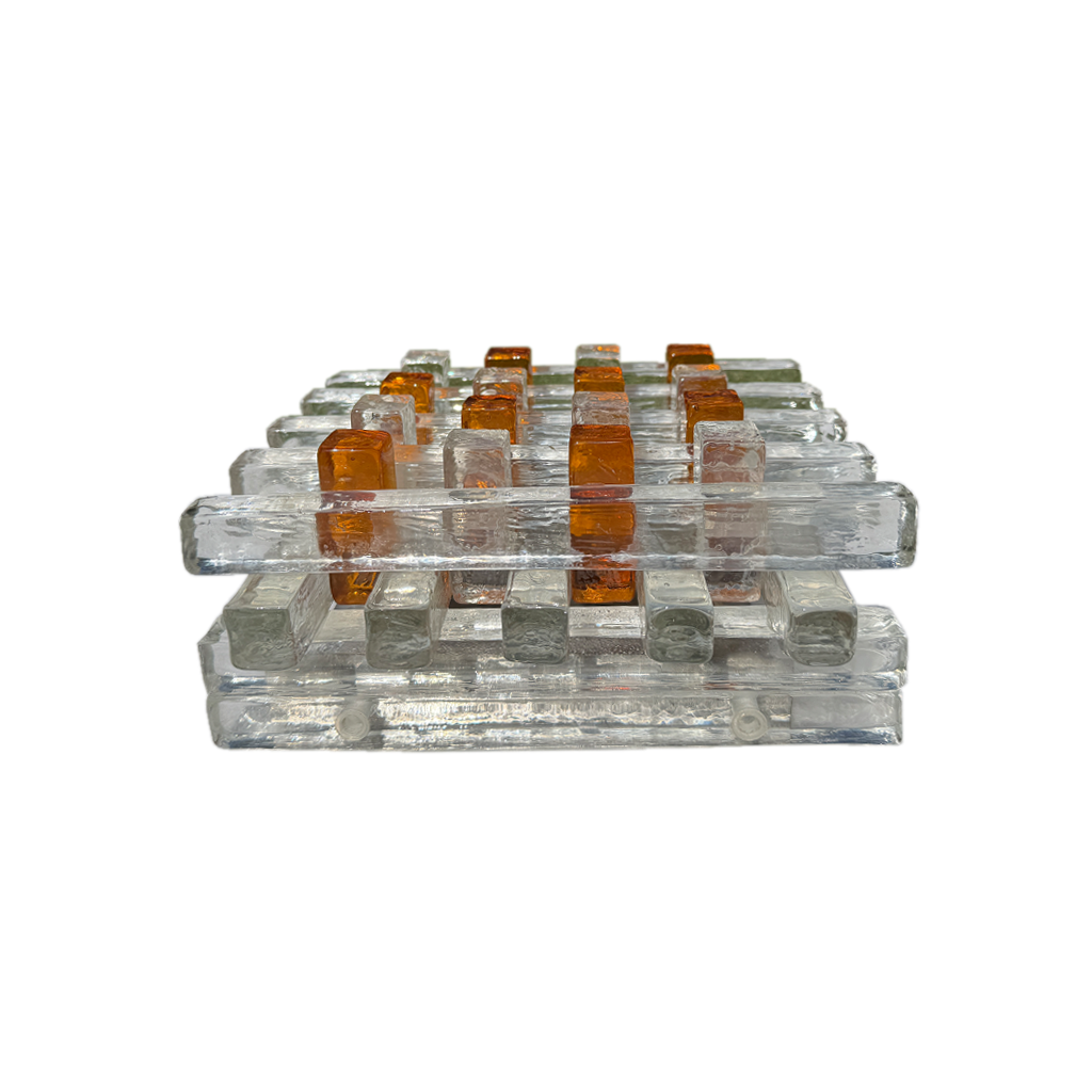 A set of clear acrylic or glass trays and small square containers arranged in rows on a plain white background.