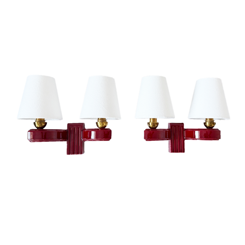 Pair of French Art Deco burgundy ceramic twin-arm wall sconces with white linen shades, 1930s