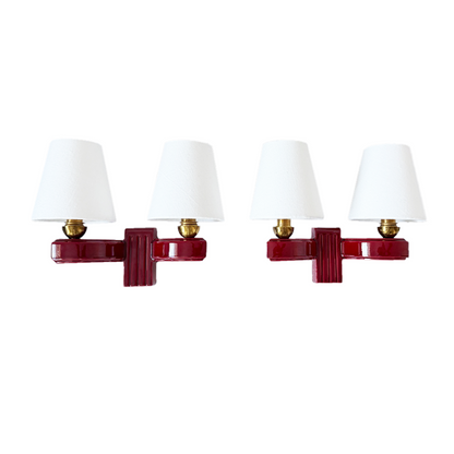 Pair of French Art Deco burgundy ceramic twin-arm wall sconces with white linen shades, 1930s