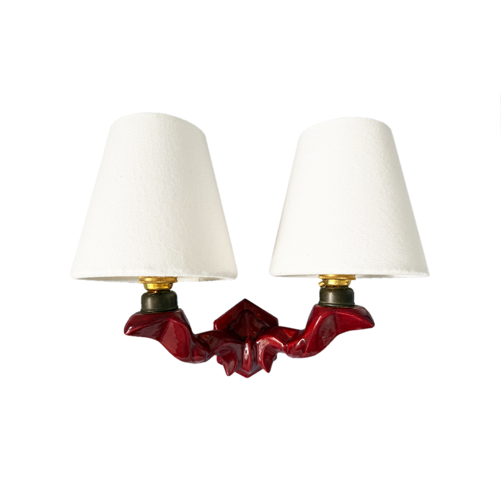 1950s French twin-arm wall light with burgundy glazed hexagonal ceramic base, curved brass arms and white linen shades