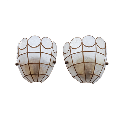 A pair of vintage-style wall sconces with scalloped, textured white glass shades and a bronze grid pattern, shown against a plain white background.