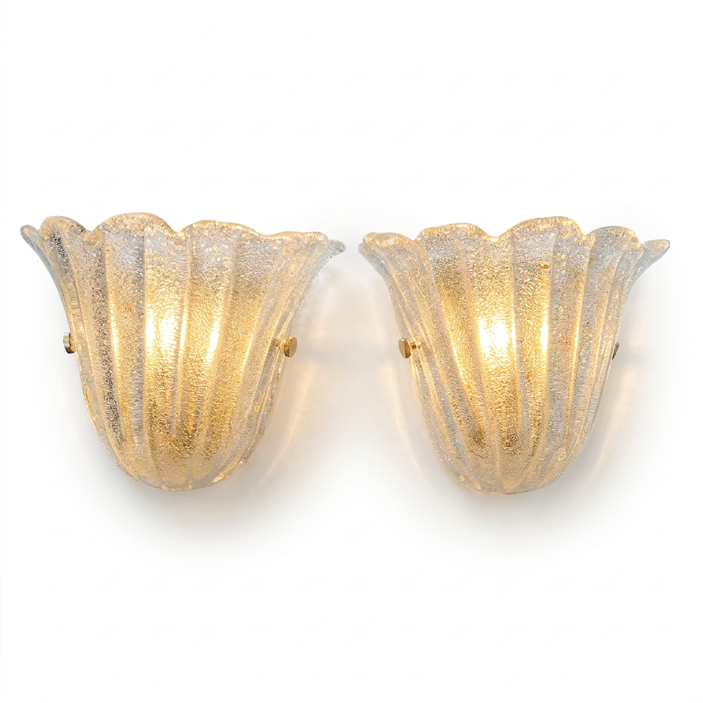 A pair of vintage-style wall sconces with fluted, tulip-shaped glass shades. The glass has a textured, crackled finish and glows with a warm golden light, mounted on a plain white background.