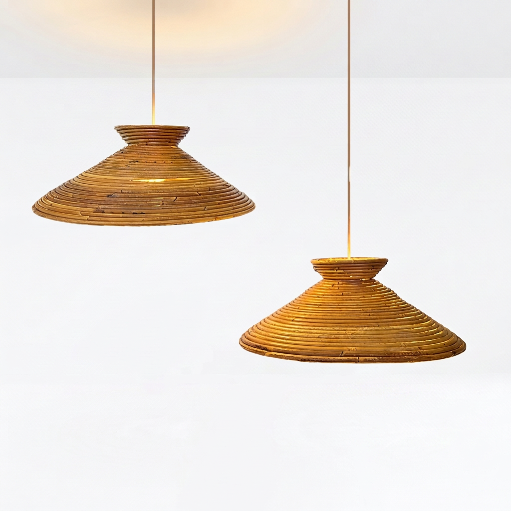 Two woven pendant light shades made of natural brown and golden-brown material, suspended by thin cords against a clean white background.