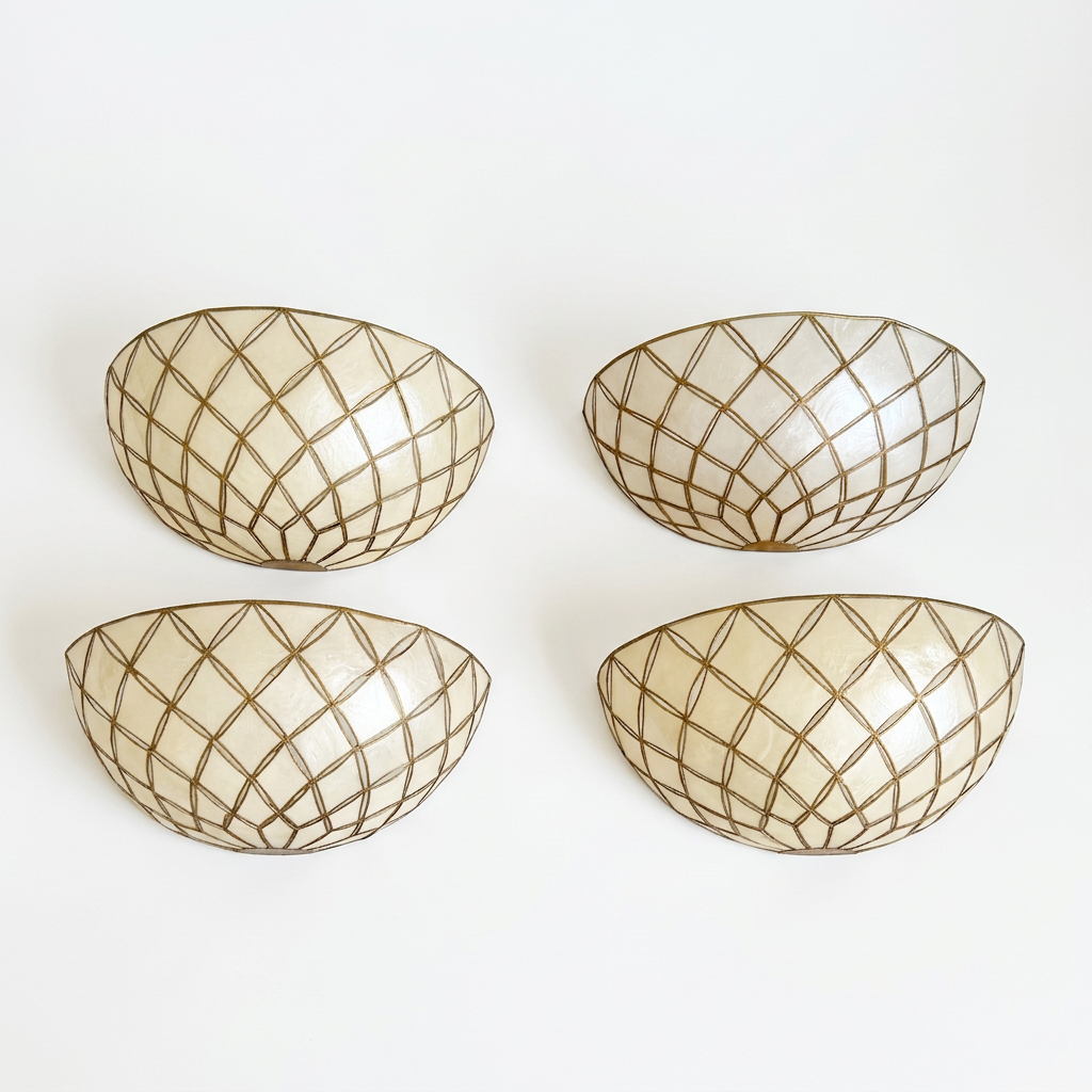 Four oval wall-mounted bowls with a cream-colored interior and a metallic gold geometric lattice pattern, arranged in a 2x2 grid on a plain white wall.