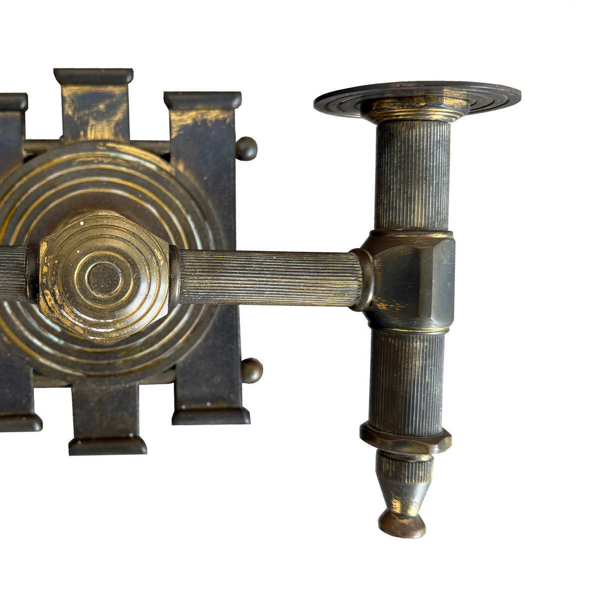 Close-up of an ornate vintage brass wall sconce or decorative metal hardware piece on a plain white background.