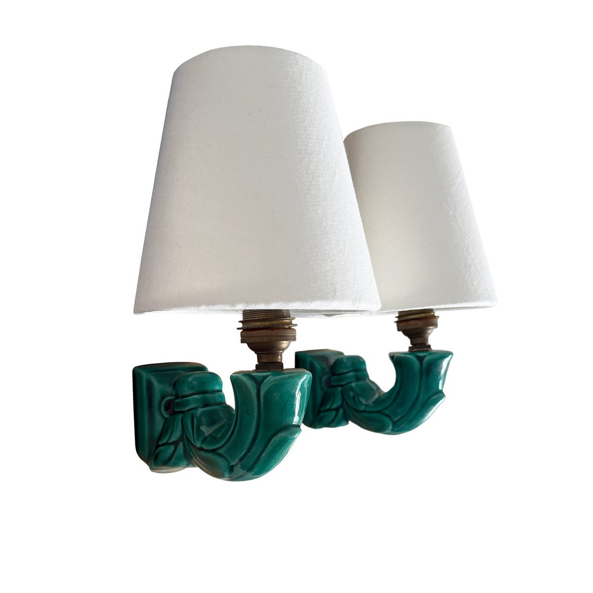 Close-up of leaf-motif relief detailing and emerald glaze on French ceramic sconce