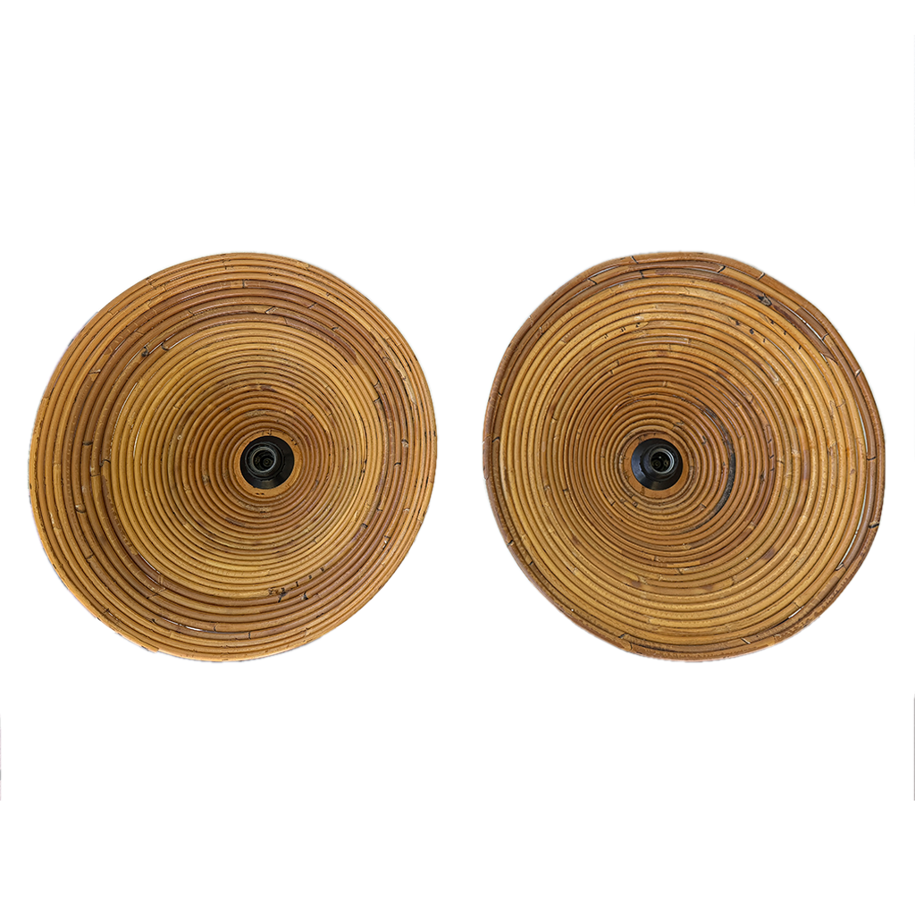 Two round woven rattan wall sconces with a natural tan and brown color palette, featuring a central black socket, shown against a plain white background.