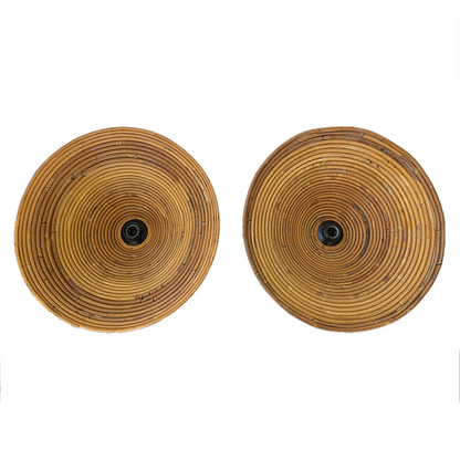 Two round woven rattan wall sconces with a natural tan and brown color palette, featuring a central black socket, shown against a plain white background.