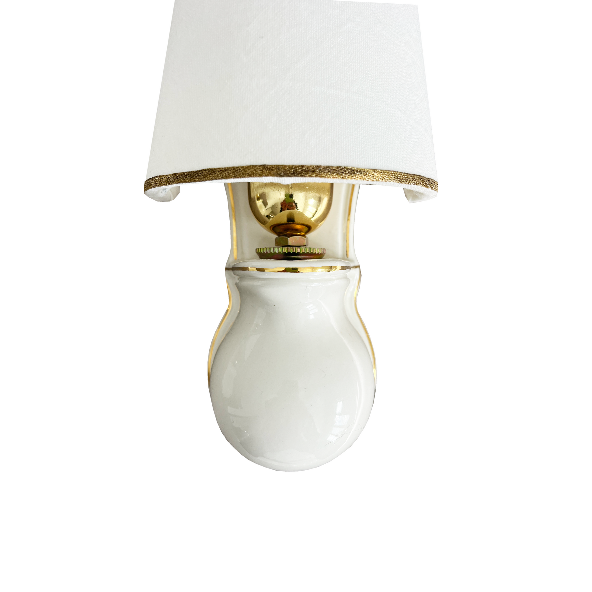 Close-up of hand-painted 24-karat gold trim on white ceramic wall light