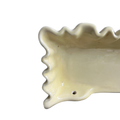 Close-up of soft pleated glaze detail on La Farnesiana butter yellow ceramic shelf