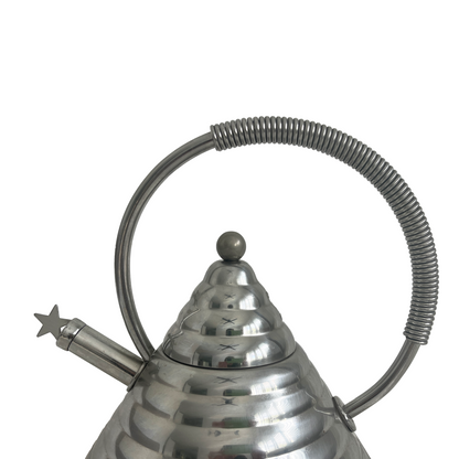 Close-up of coiled metal handle wrap and star spout detail on 1980s Italian stainless steel kettle